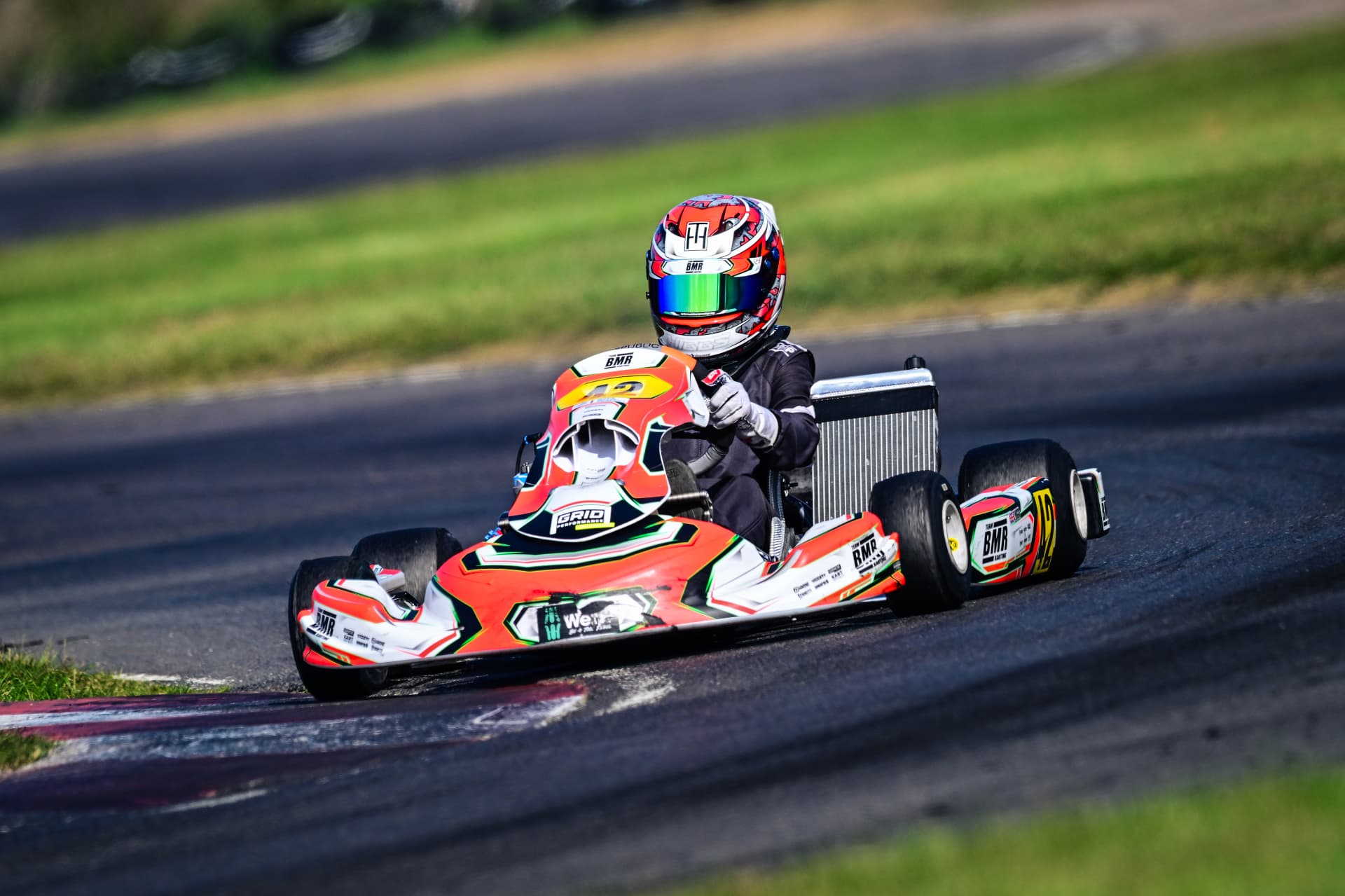 Ted Higgs taking a corner in his red, white and black kart